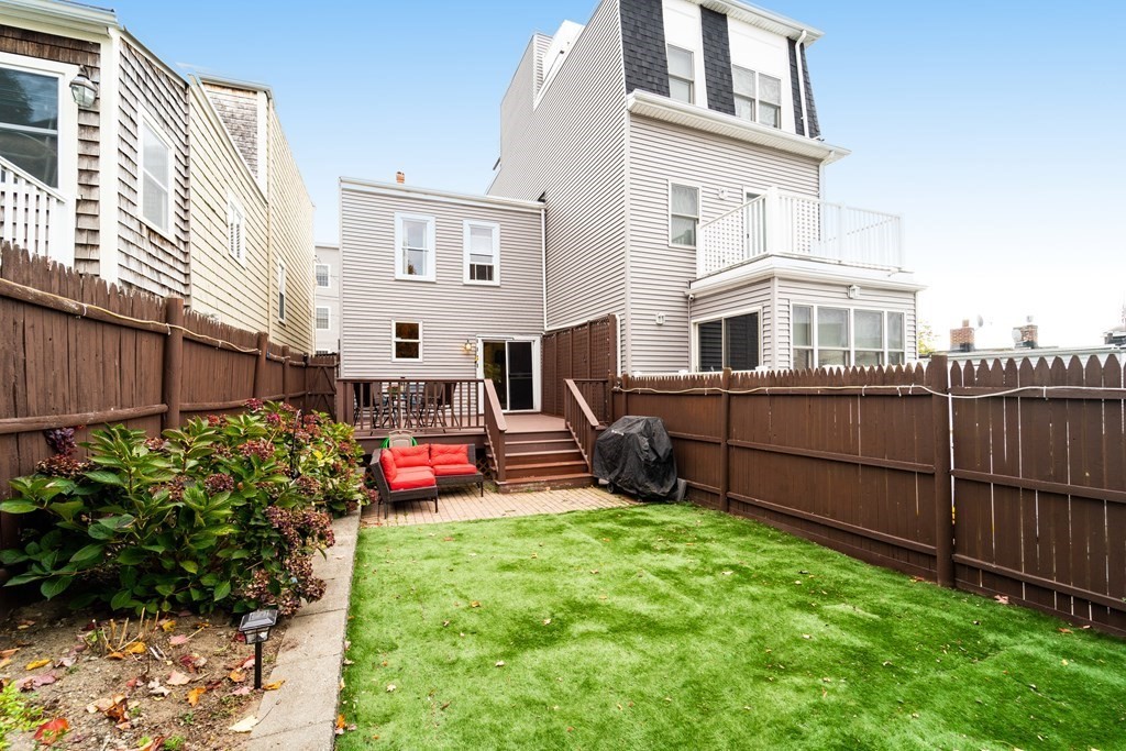 a view of a house with backyard and sitting area