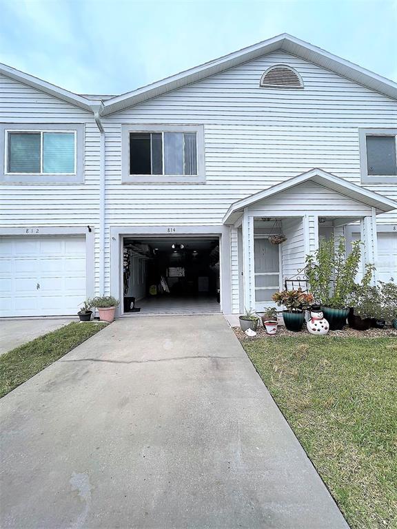 a view of a house with a yard and garage