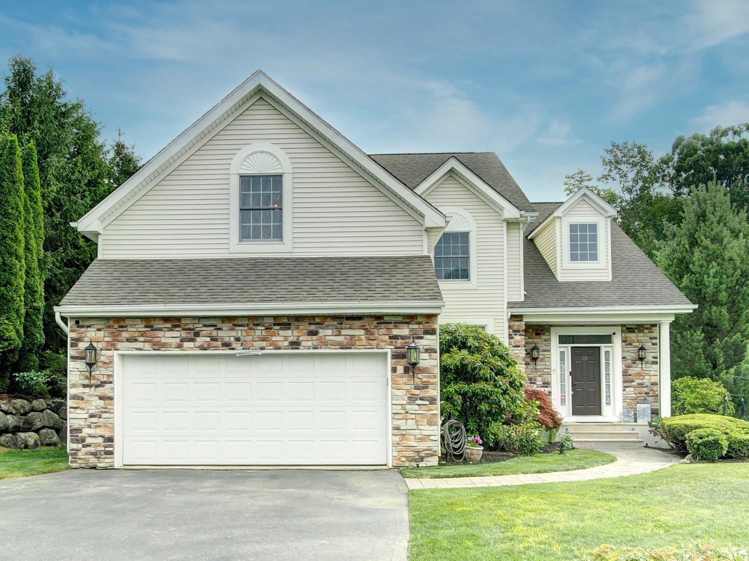 a front view of a house with a yard and garage