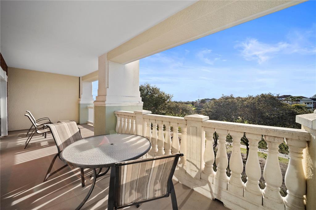 a view of a chair and table in the balcony