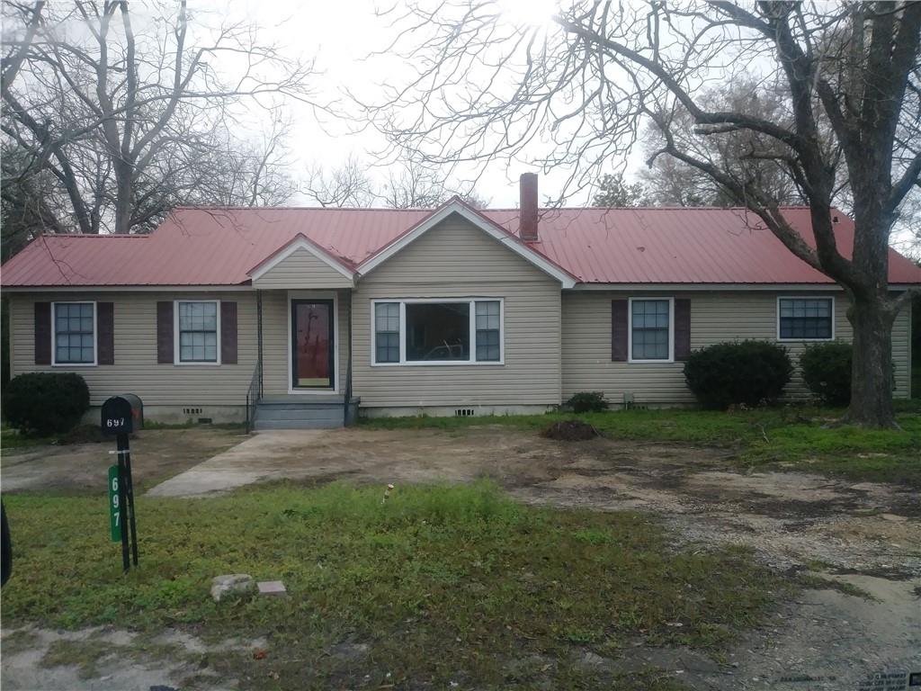 a house that has a tree in front of it