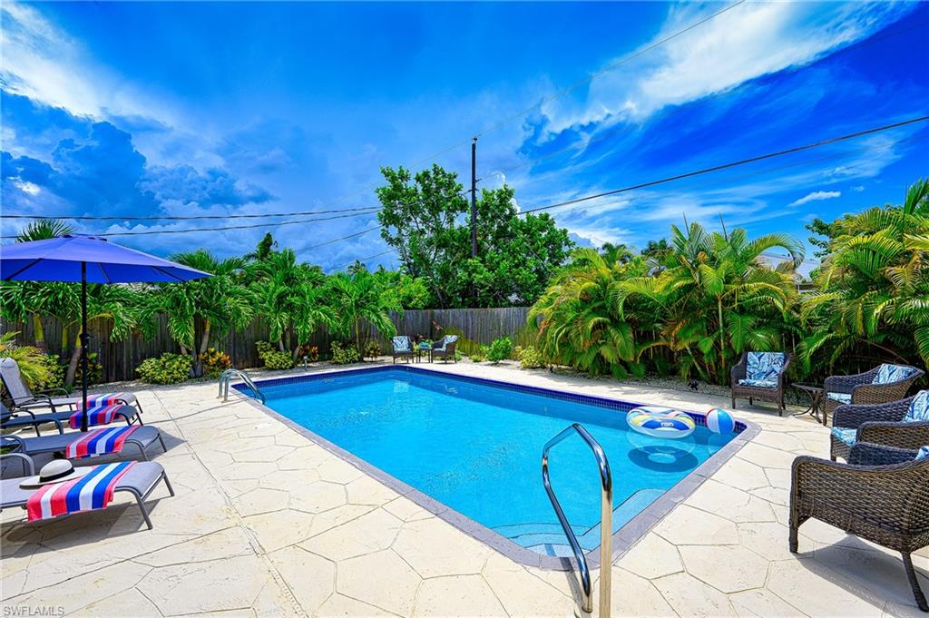 a swimming pool with potted plants