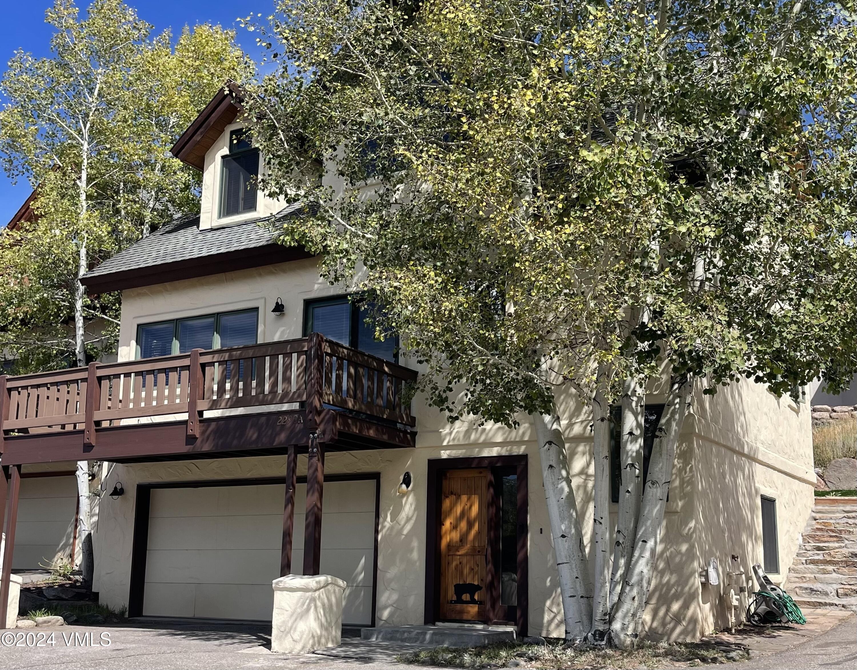 a front view of a house with a tree