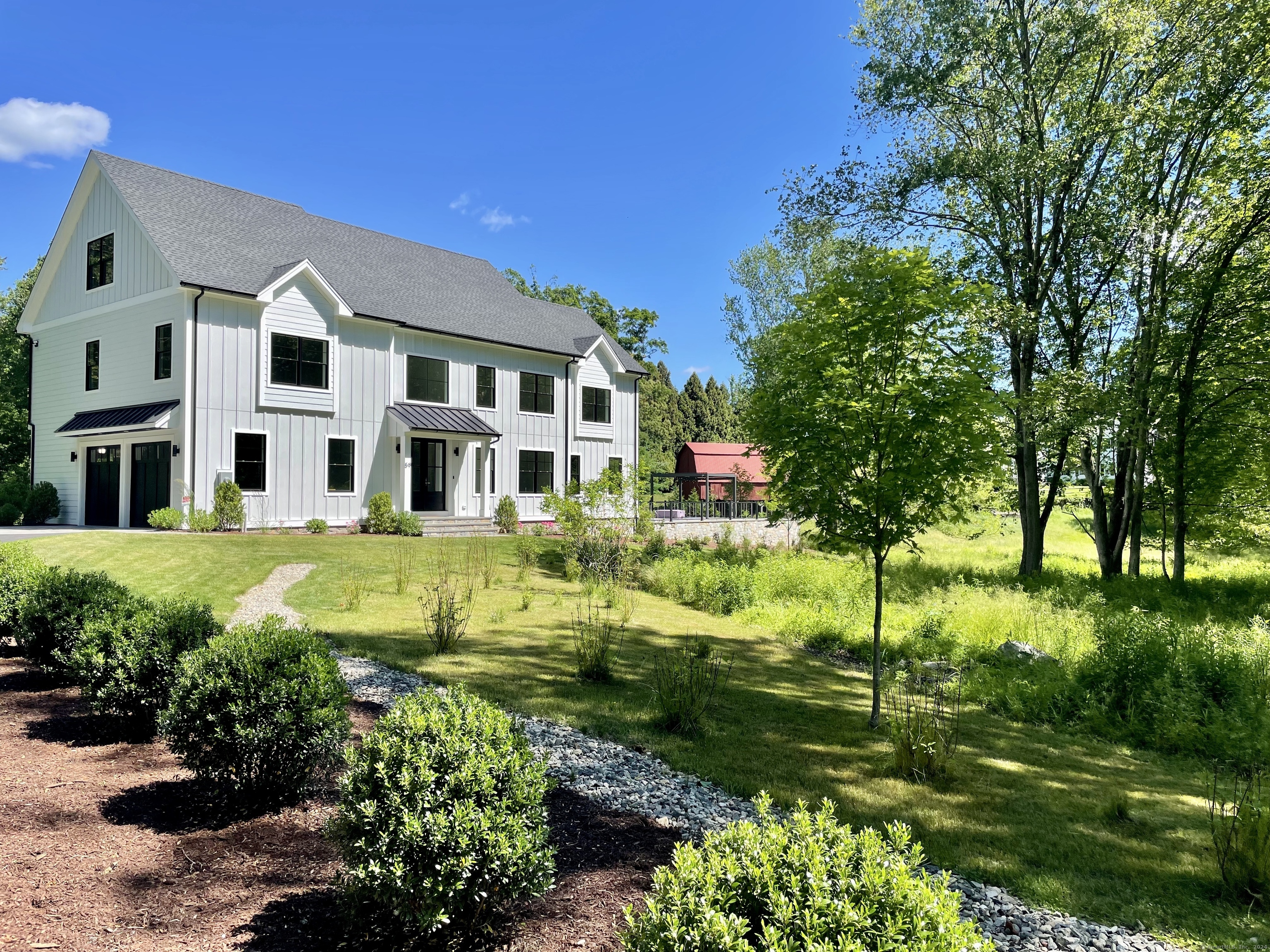 a view of residential houses with yard and green space