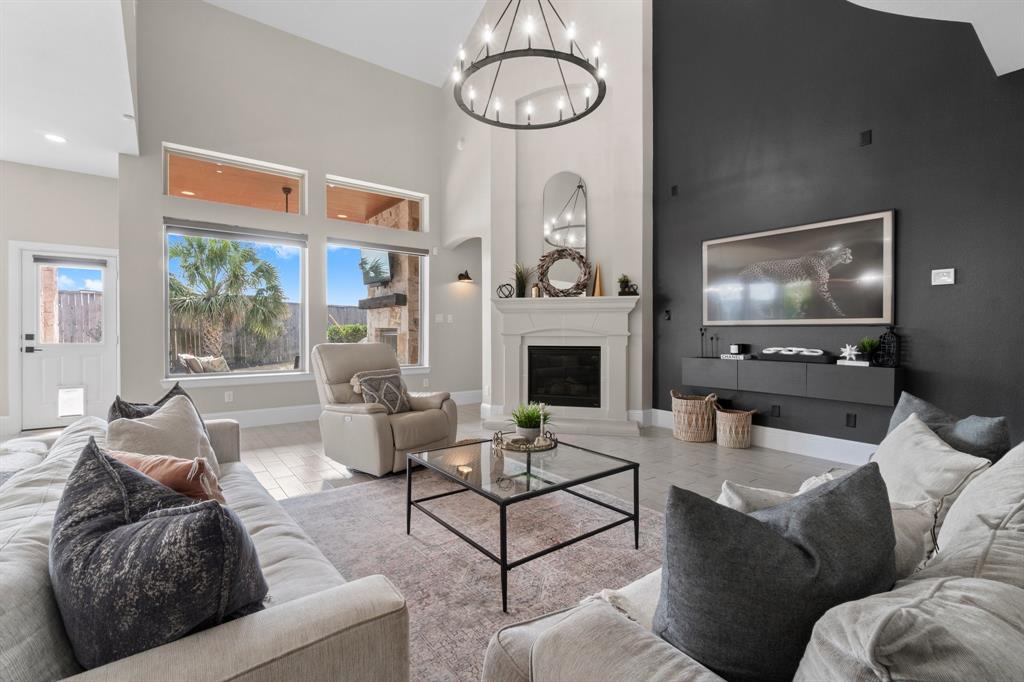 a living room with furniture a large window and a fireplace