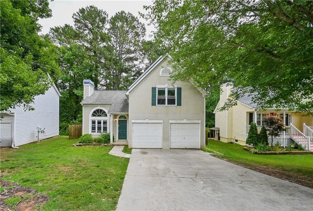 a front view of house with yard and green space