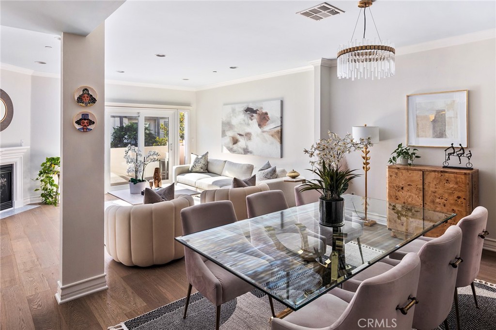 a dining room with furniture a rug and wooden floor