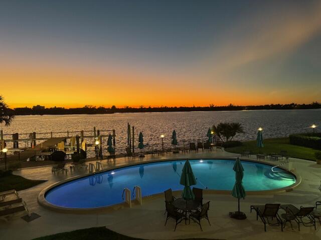 a view of a swimming pool with furniture