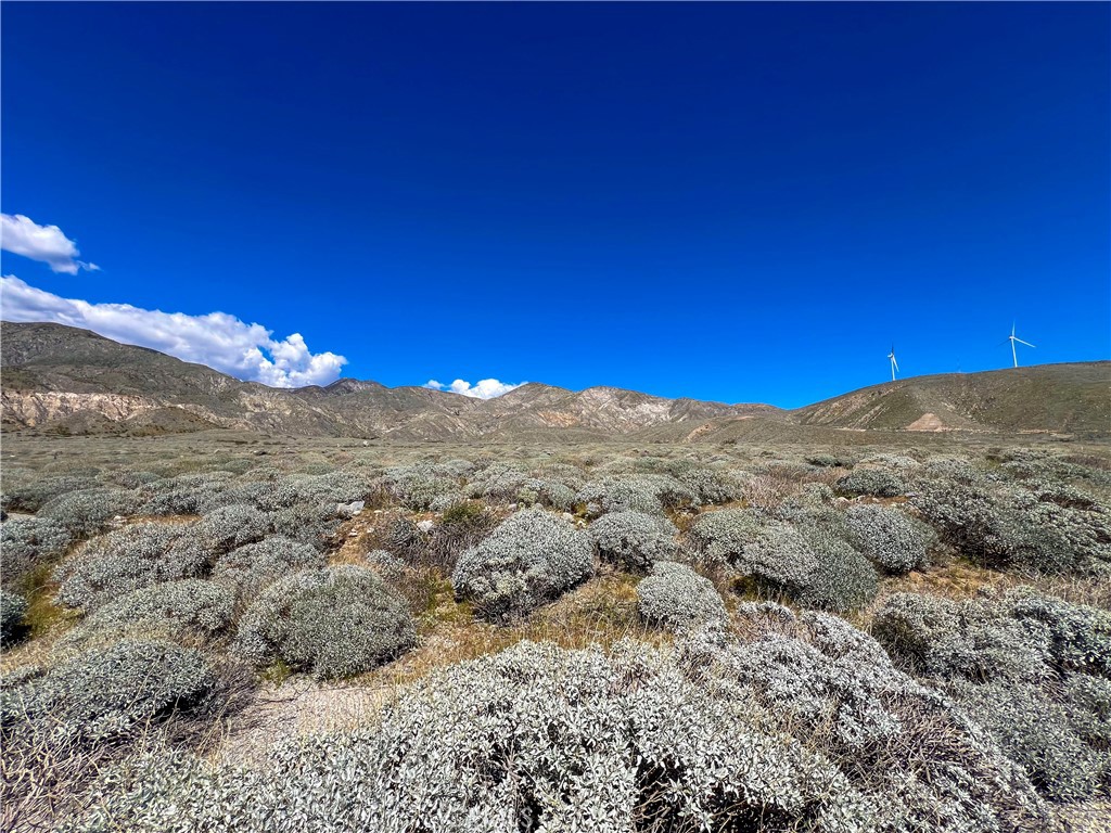 a view of a large mountain with mountains in the background