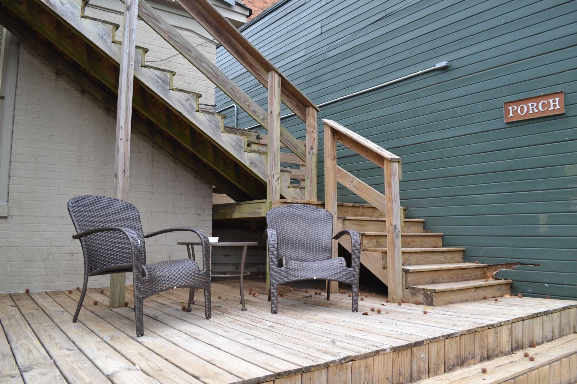 a view of deck with chairs and wooden fence