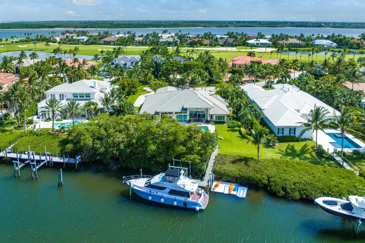 an aerial view of a house with a garden and lake view