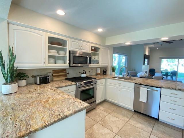 a kitchen with a stove a sink and a microwave