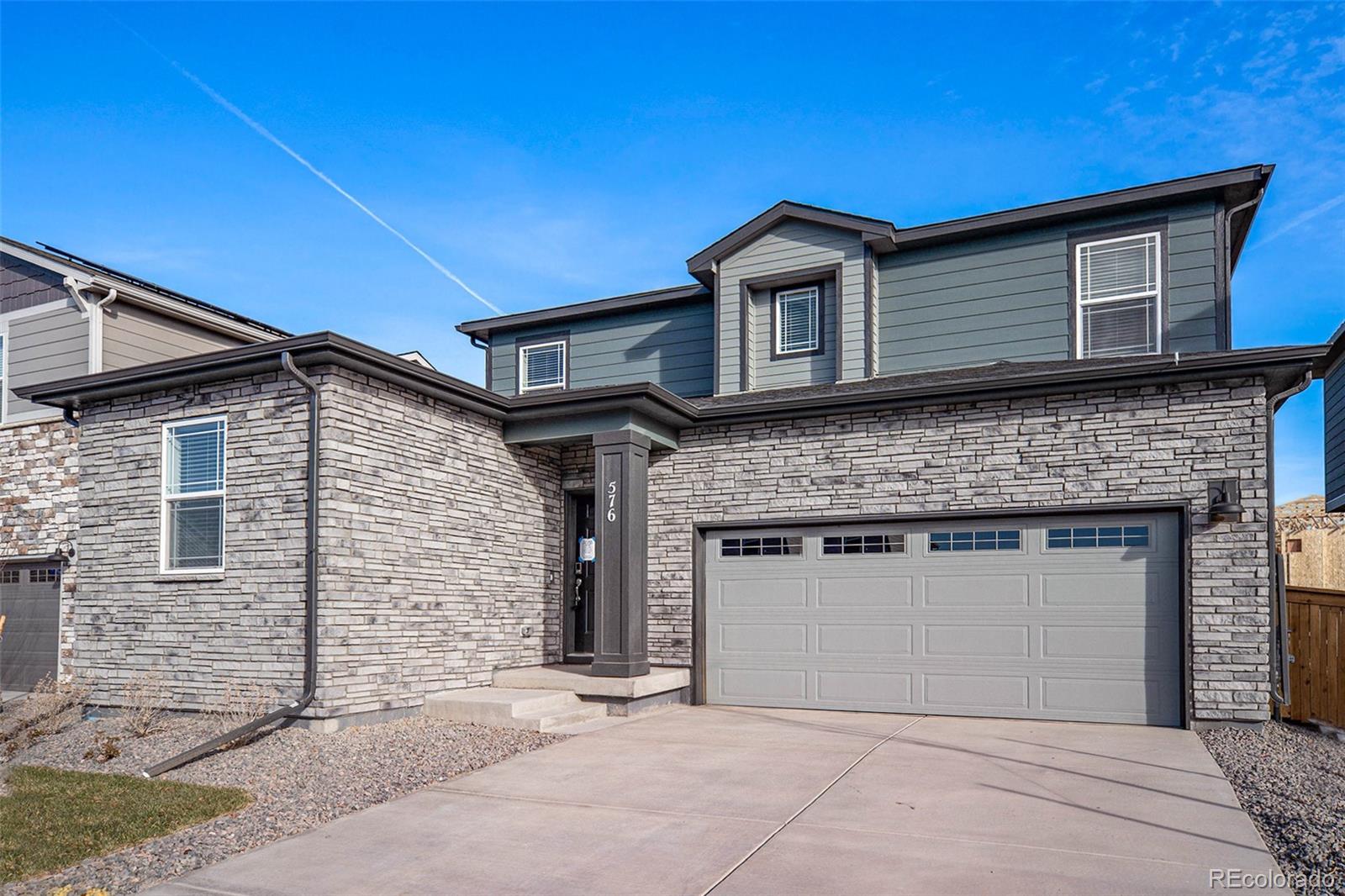 a front view of a house with garage