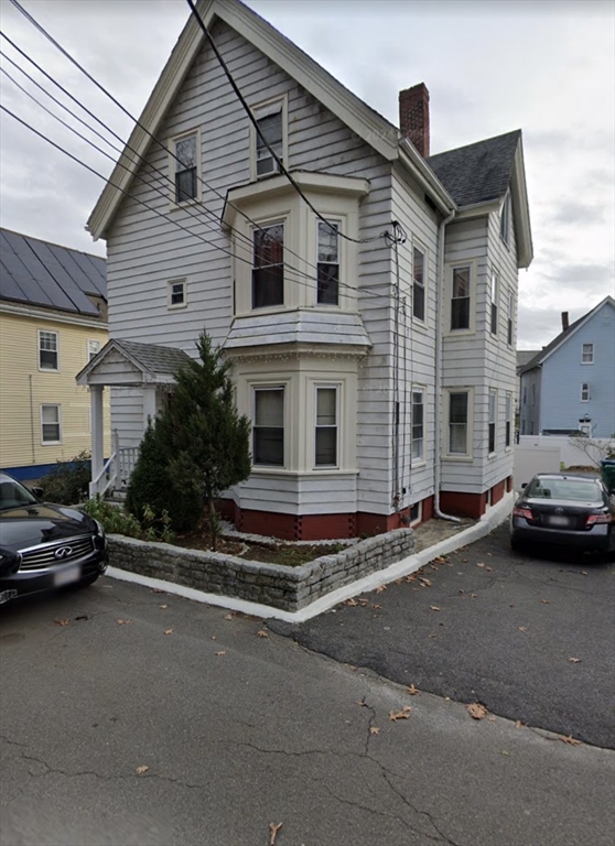 a view of a street that has couple of cars parked on the road