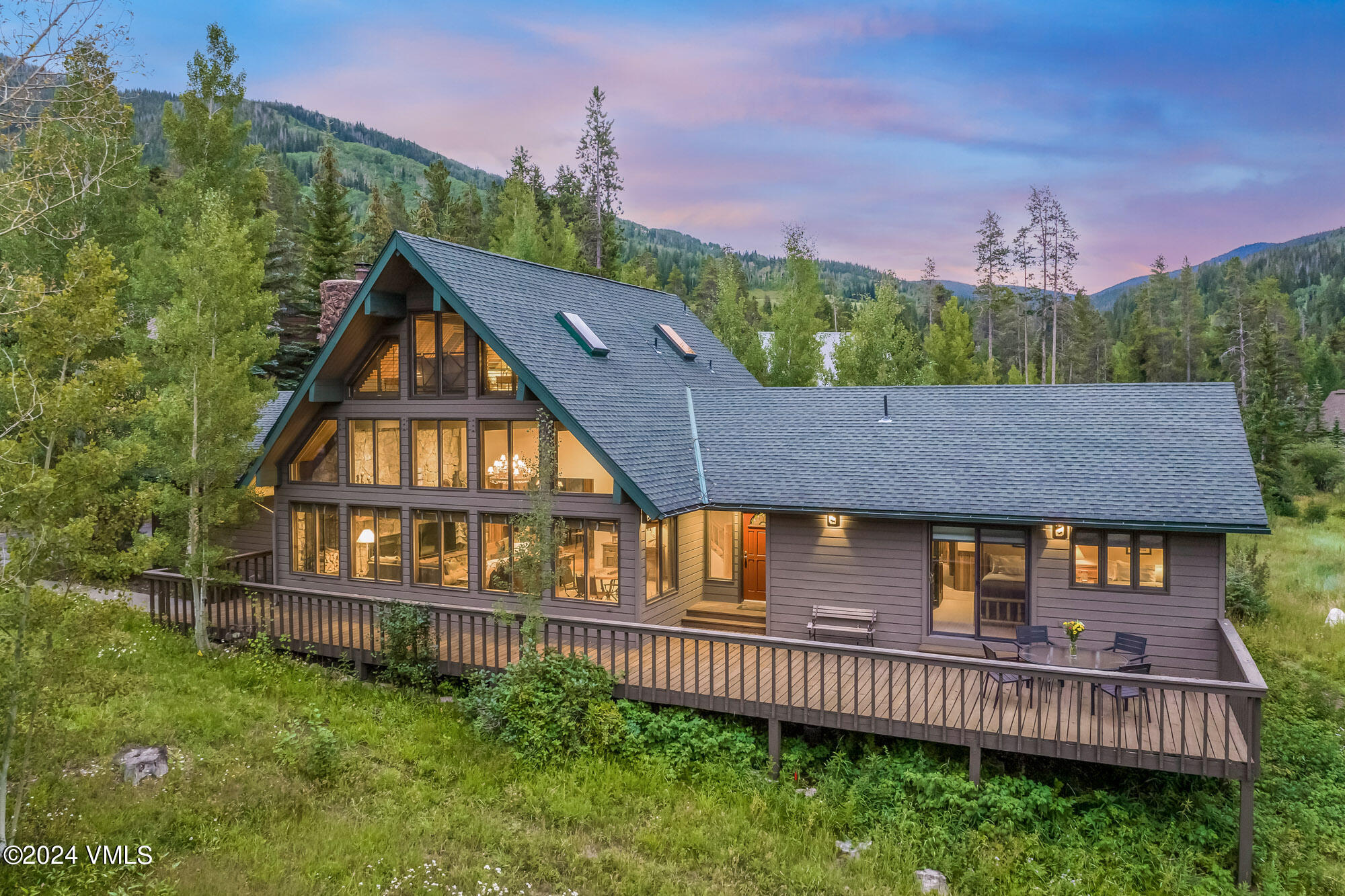 a aerial view of a house with a yard and deck