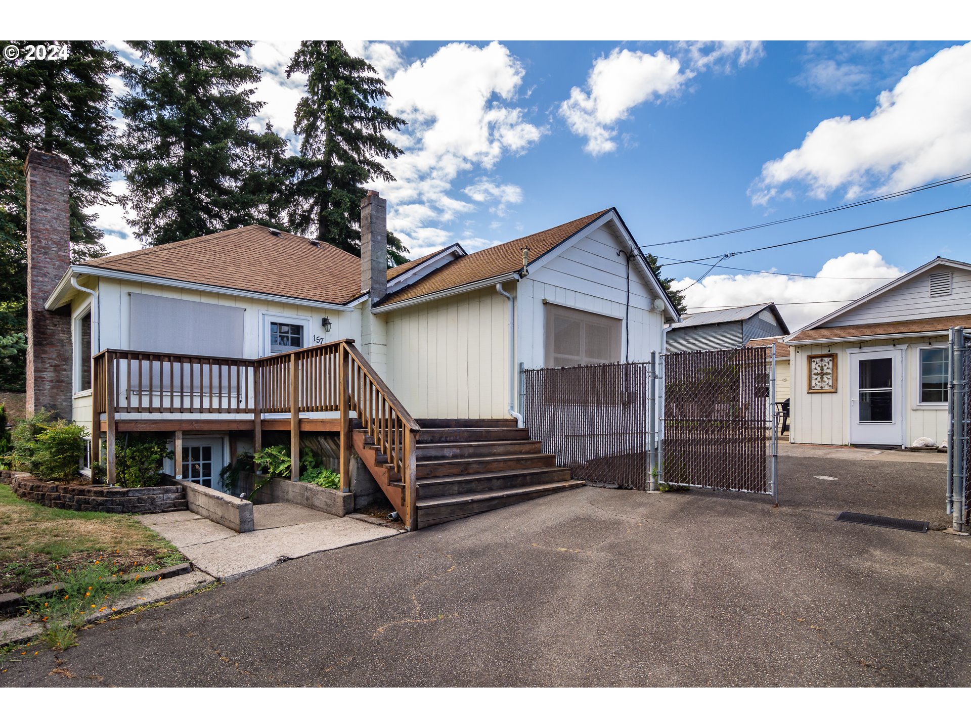 a view of a house with a yard and deck