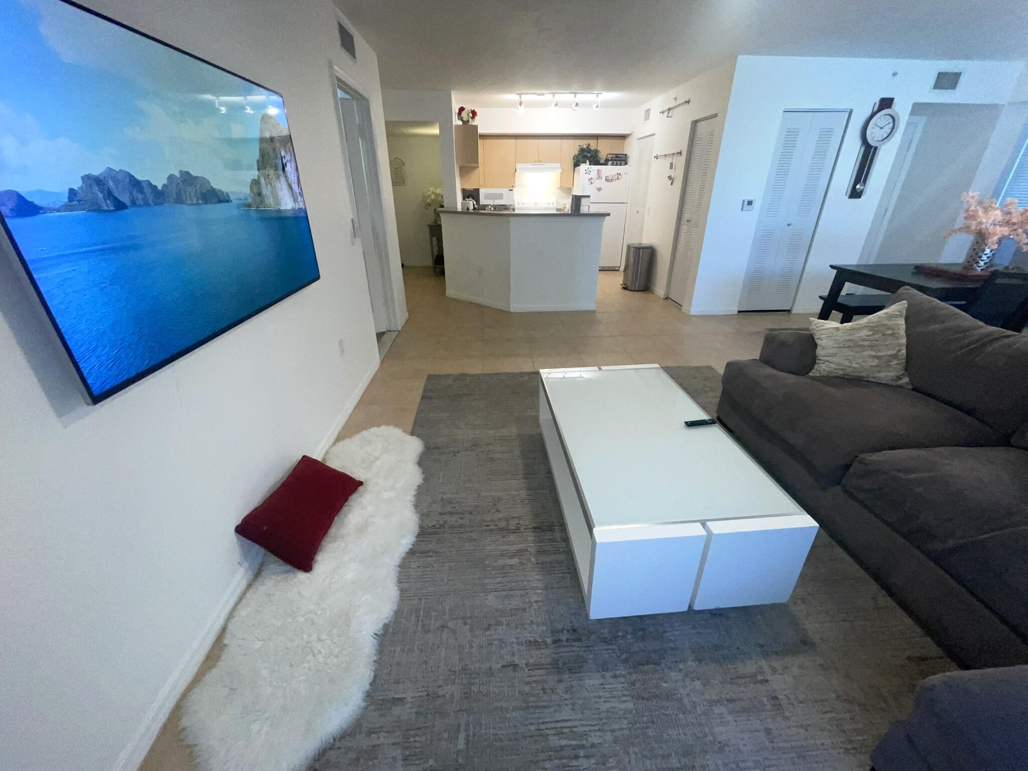 a living room with furniture and kitchen view