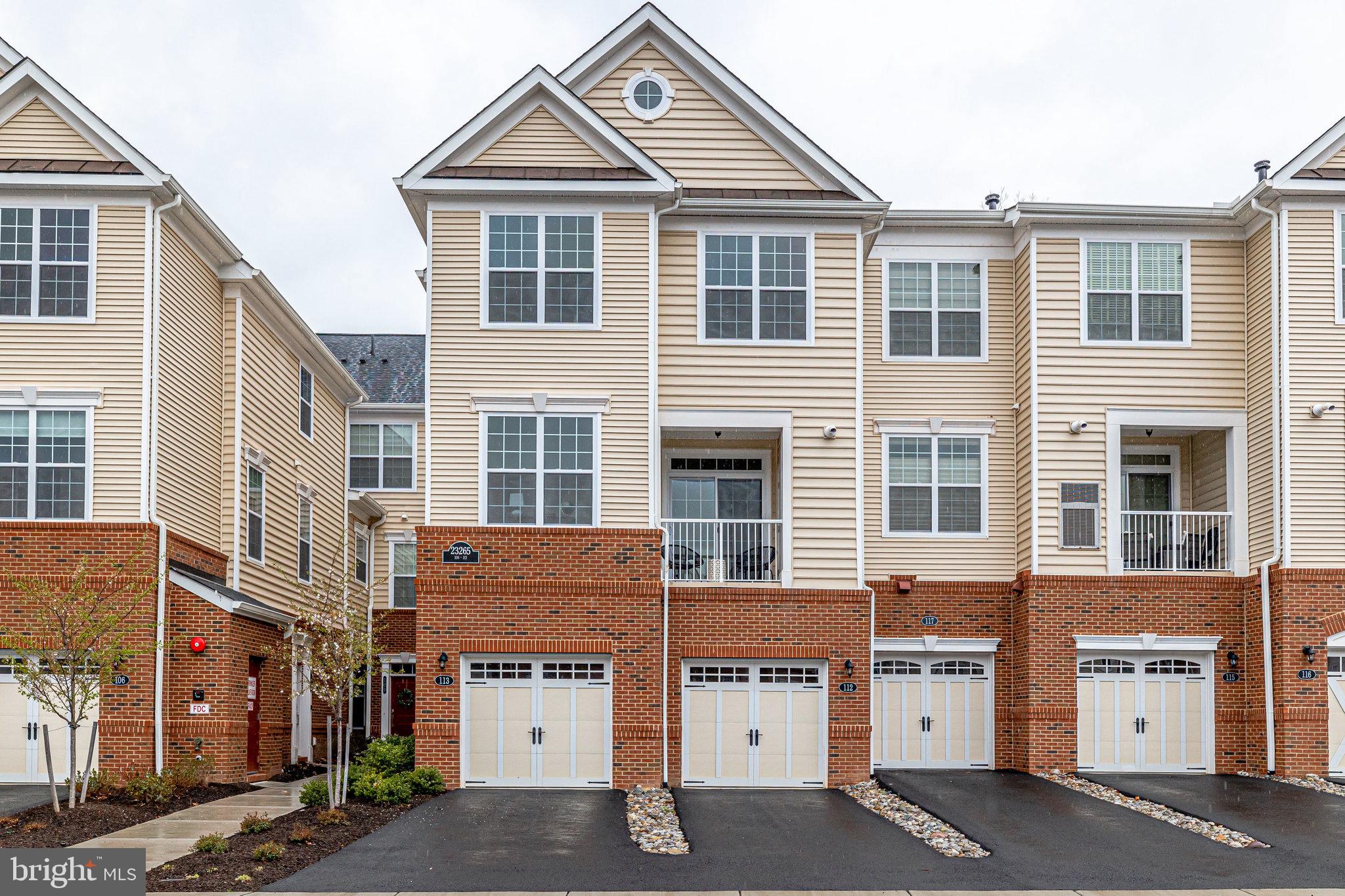 a front view of a residential apartment building with a yard