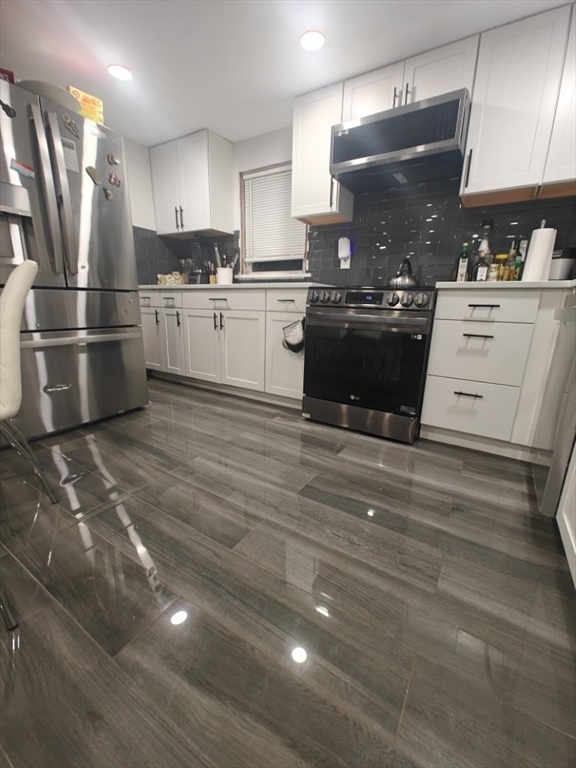 a kitchen with stainless steel appliances a refrigerator sink and cabinets