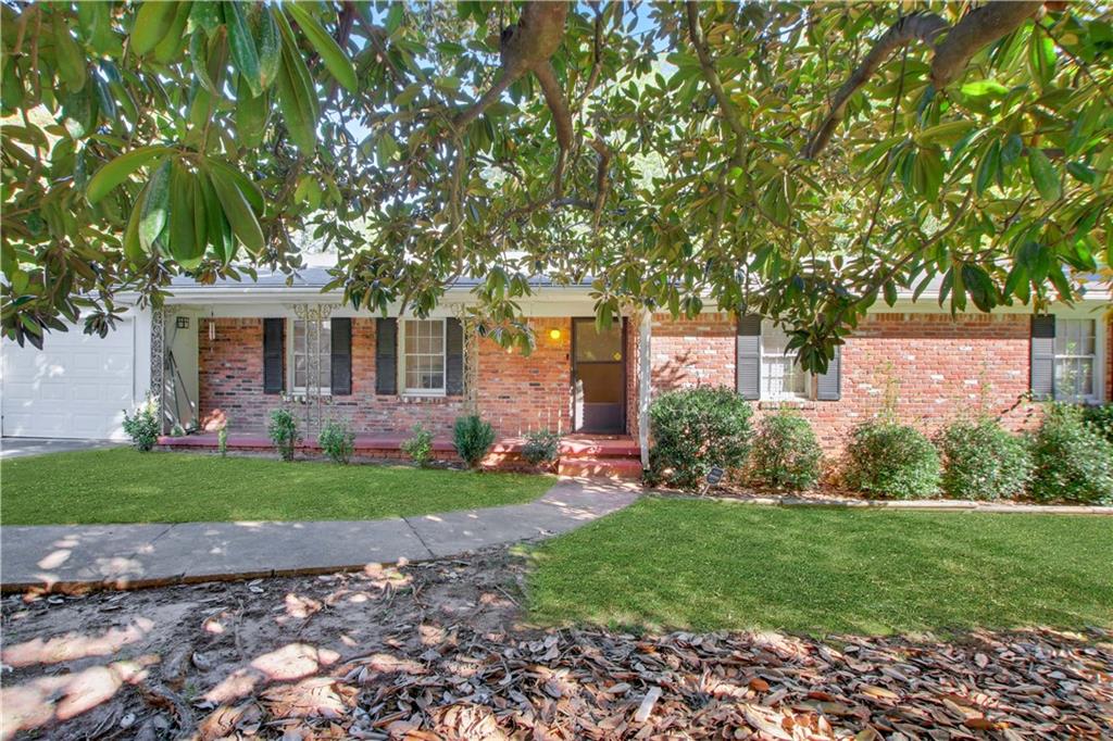 a front view of a house with a garden and yard