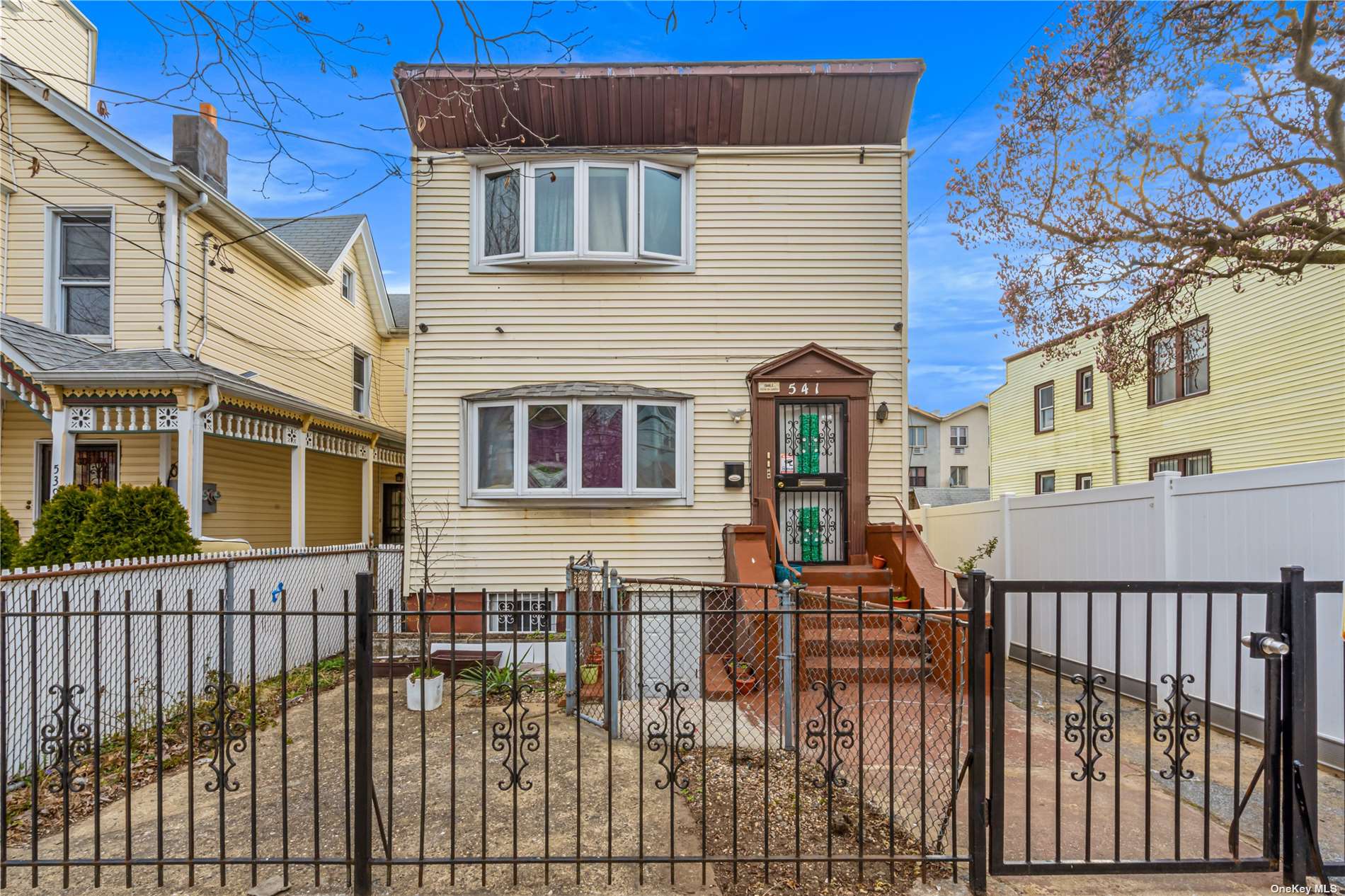 a front view of a house with a fence