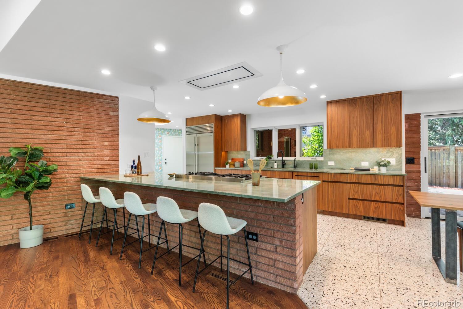 a large kitchen with a table and chairs