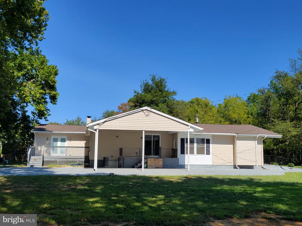 a front view of a house with a garden and trees