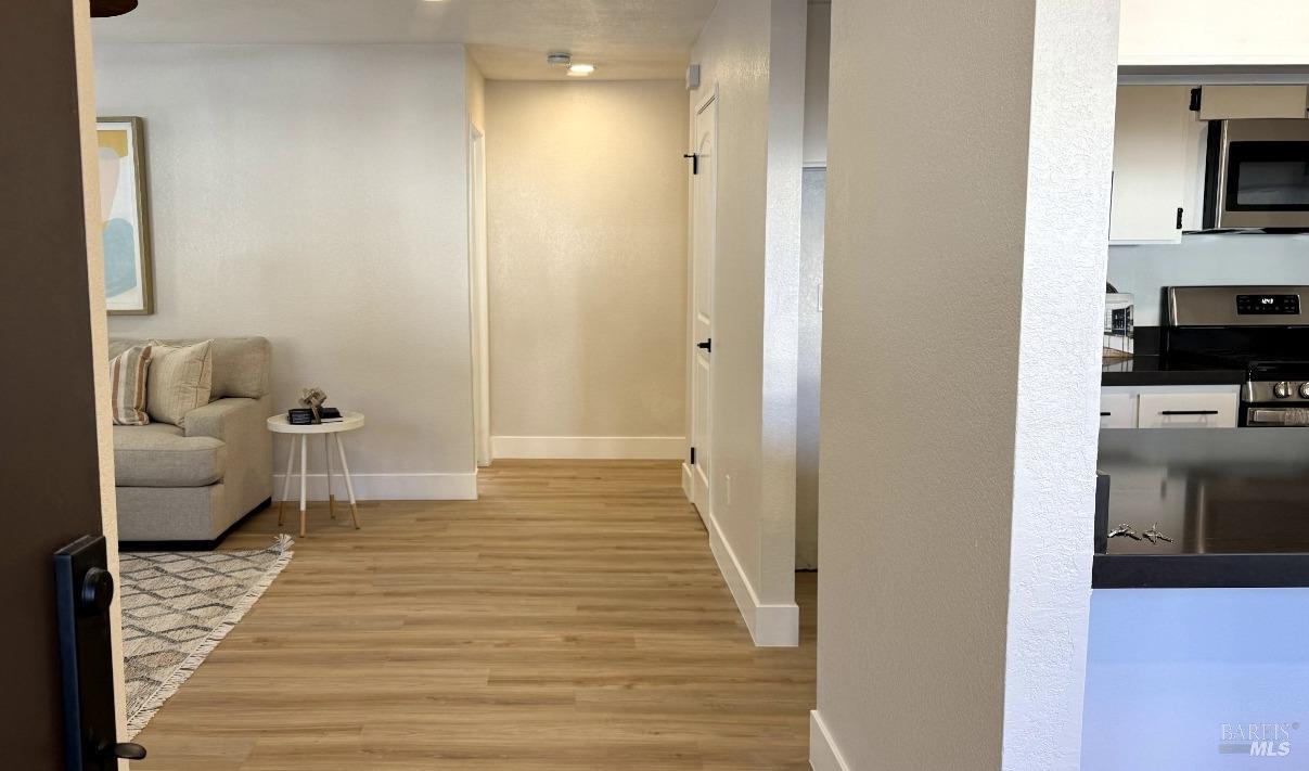 a view of a bedroom with wooden floor and furniture