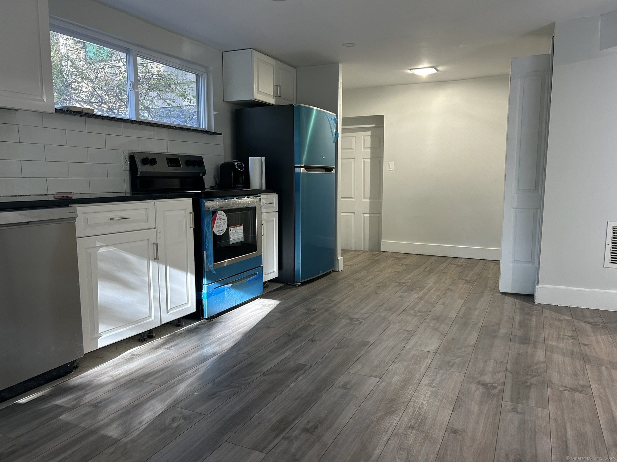 a kitchen with stainless steel appliances a refrigerator and a stove top oven