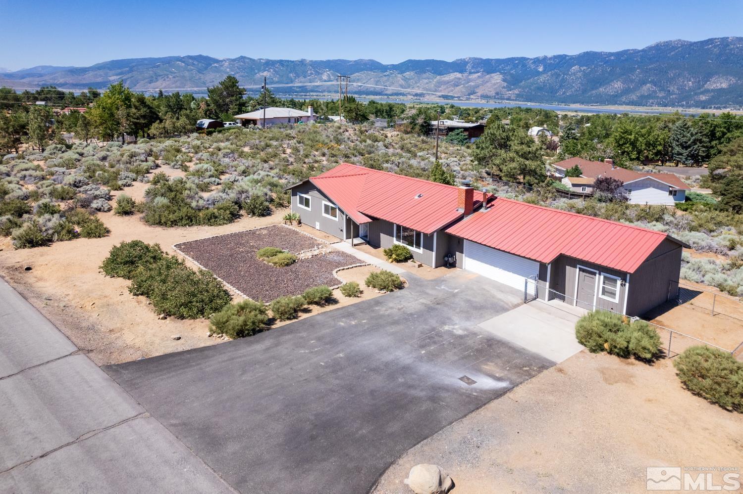 an aerial view of a house with mountain view