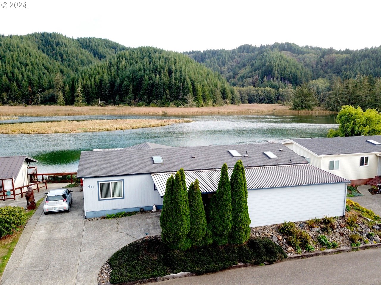 an aerial view of a house with garden space and street view