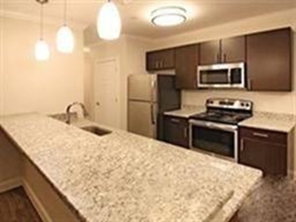 a kitchen with a sink appliances and cabinets