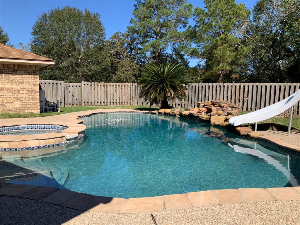 a view of a swimming pool with a garden and deck