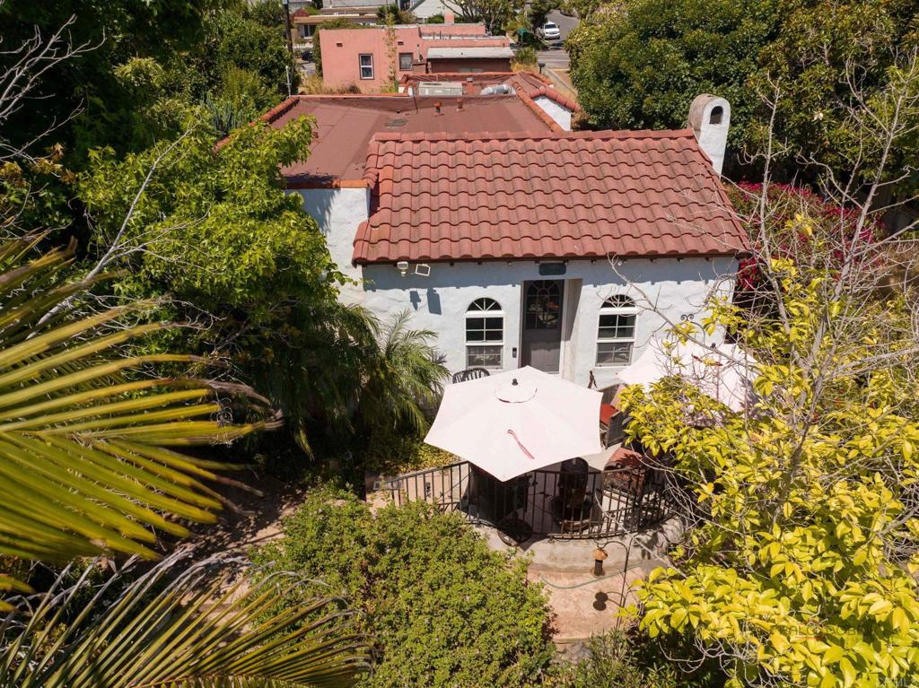 an aerial view of a house with a yard and balcony