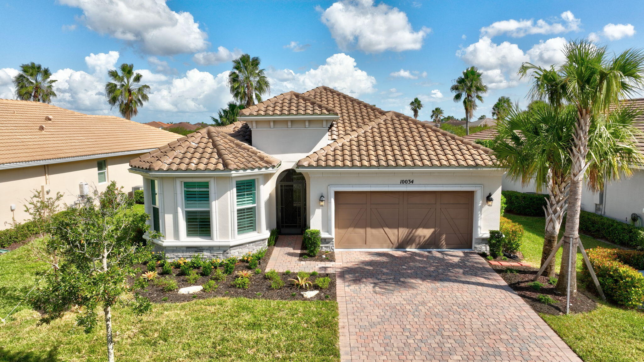 a front view of a house with garden