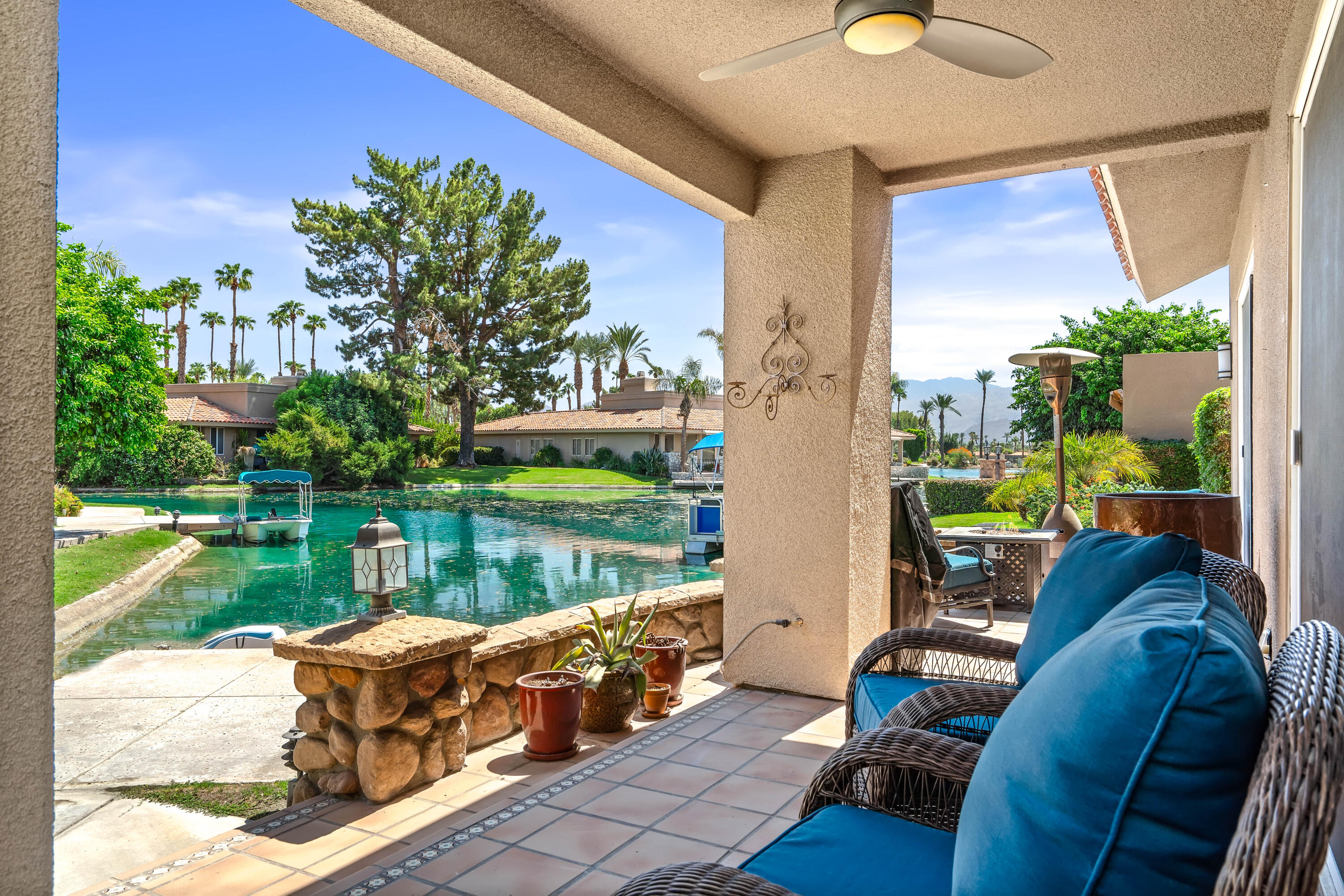 a building outdoor space with patio furniture and a lake view