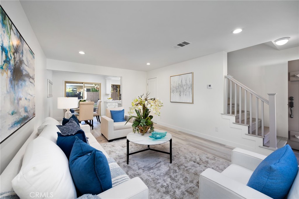 a living room with furniture and a potted plant