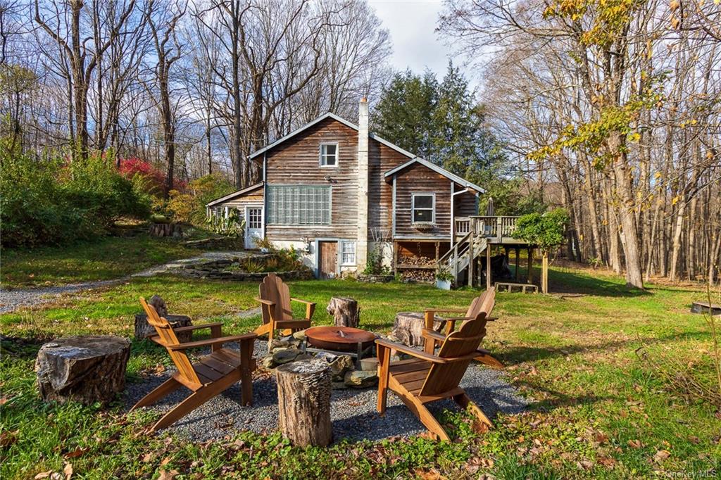 a view of a house with backyard sitting area and garden