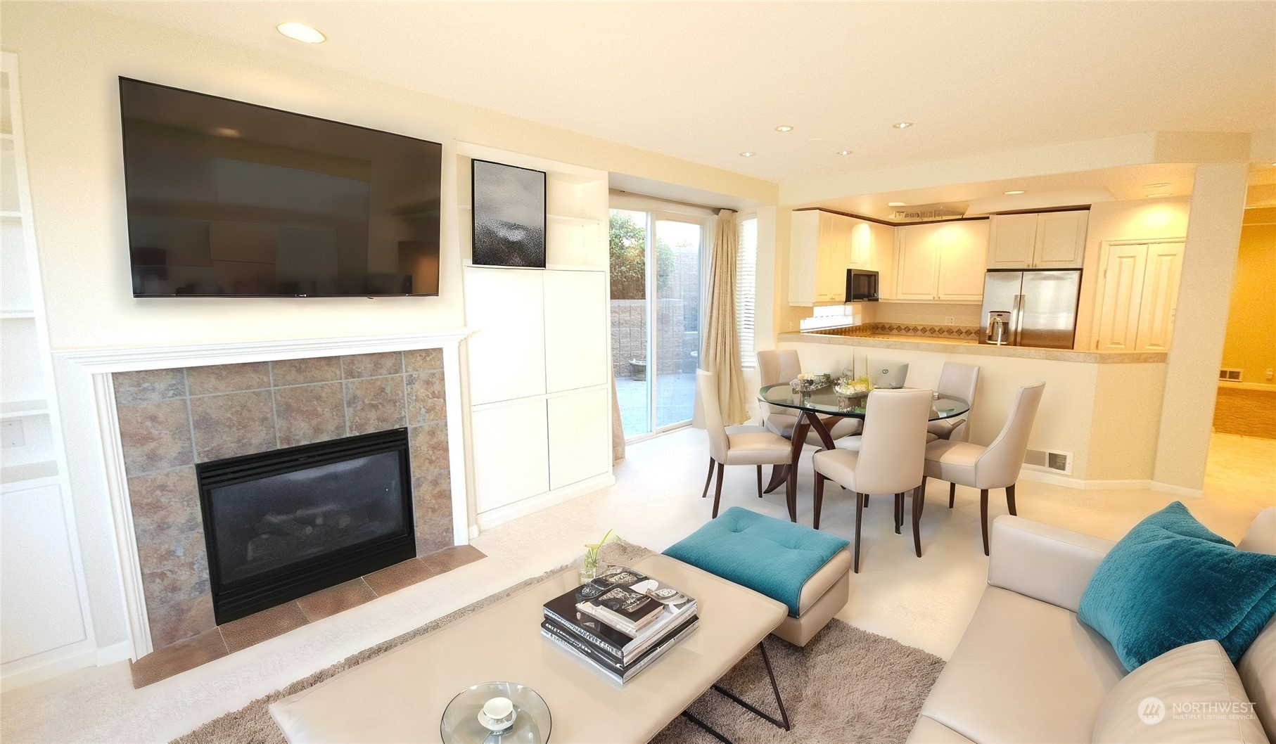 a living room with furniture a fireplace and a flat screen tv