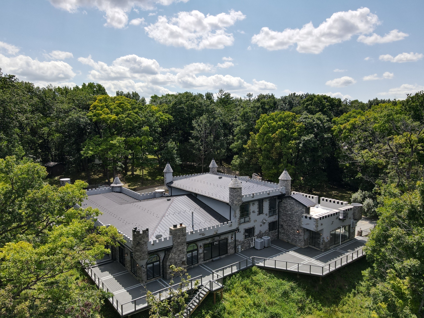 an aerial view of a house with garden space and street view