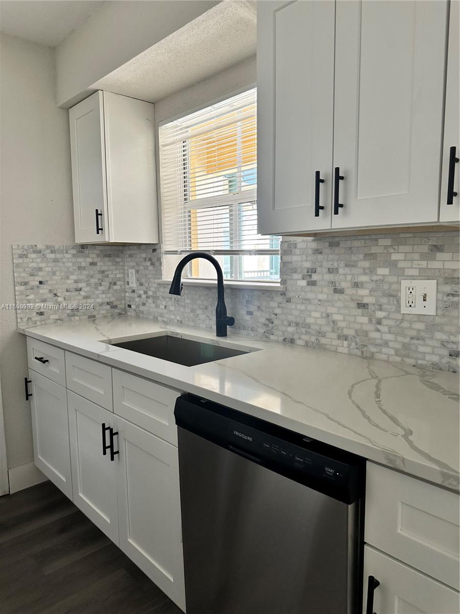 a kitchen with a sink and cabinets