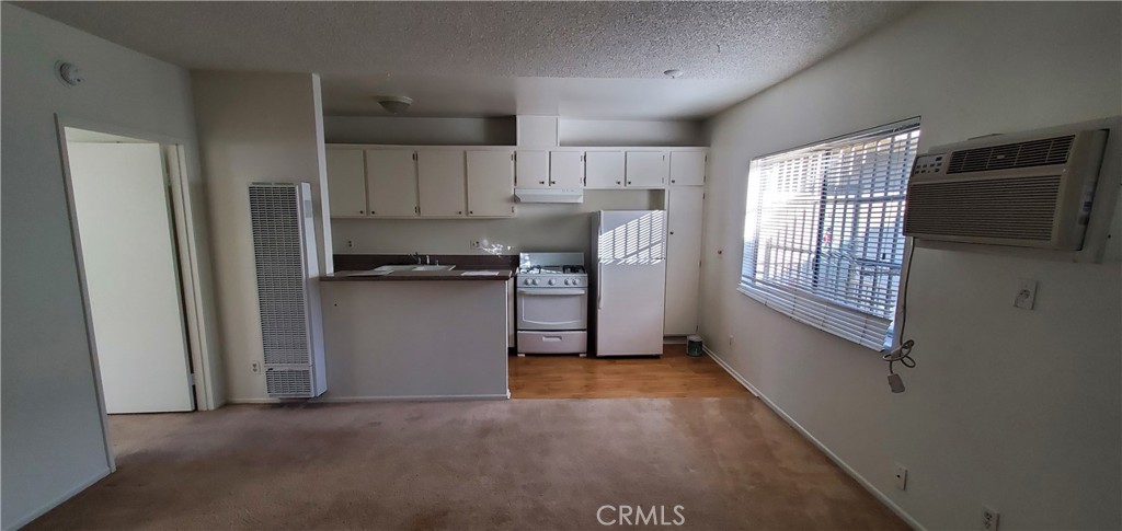 a view of a kitchen with electric appliances