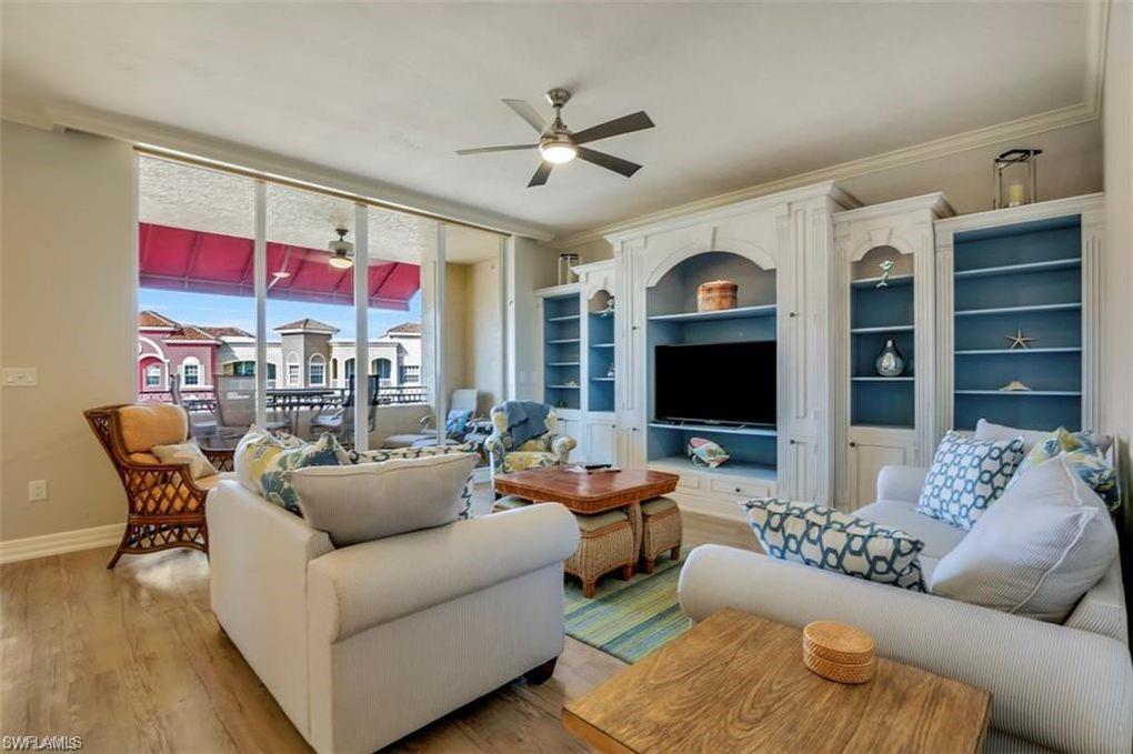 a living room with furniture kitchen view and a fireplace