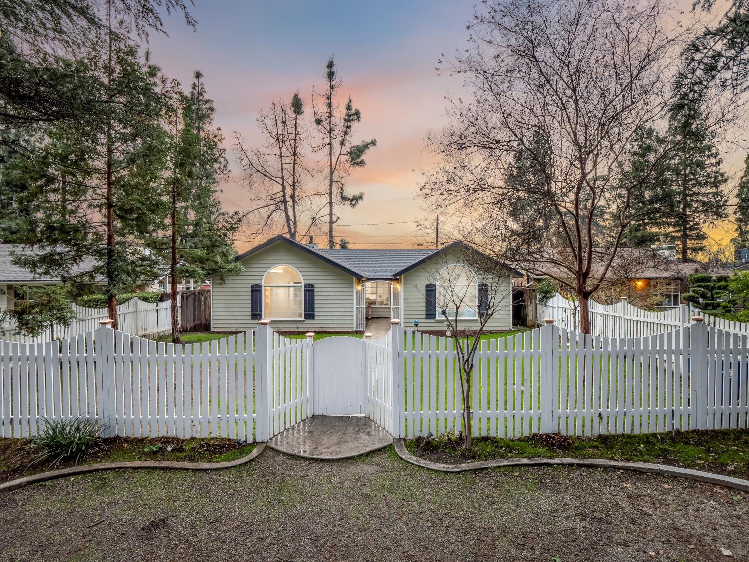 a front view of a house with a fence