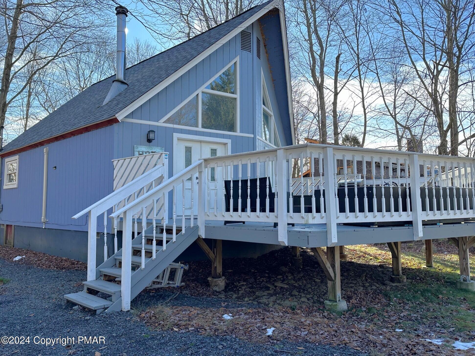 a view of a house with a yard and deck