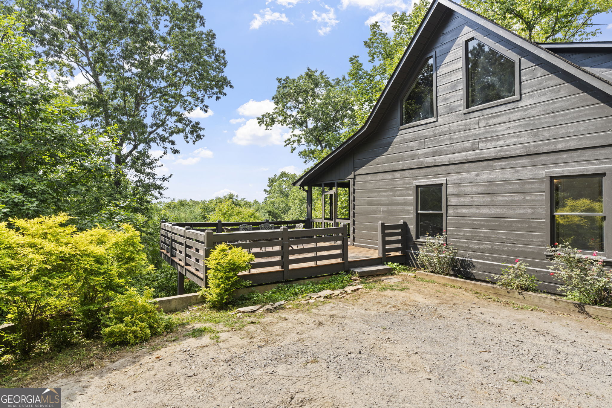 a view of a house with a yard and sitting area