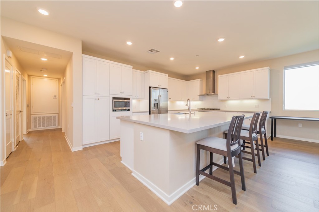 a kitchen with stainless steel appliances kitchen island granite countertop a sink and cabinets