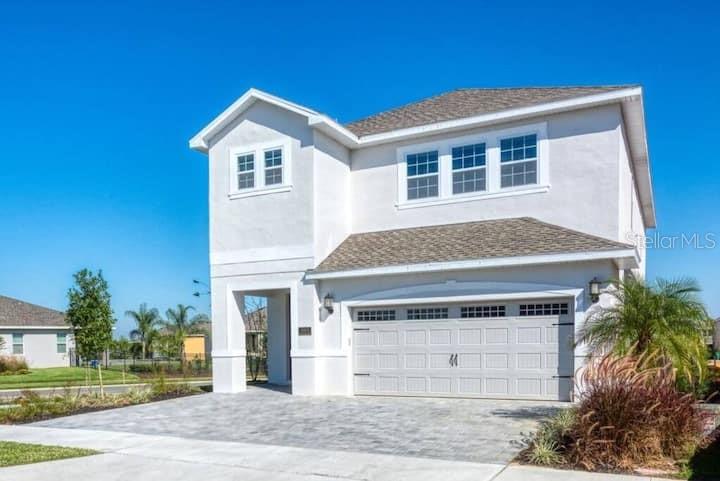 a front view of a house with a yard and garage