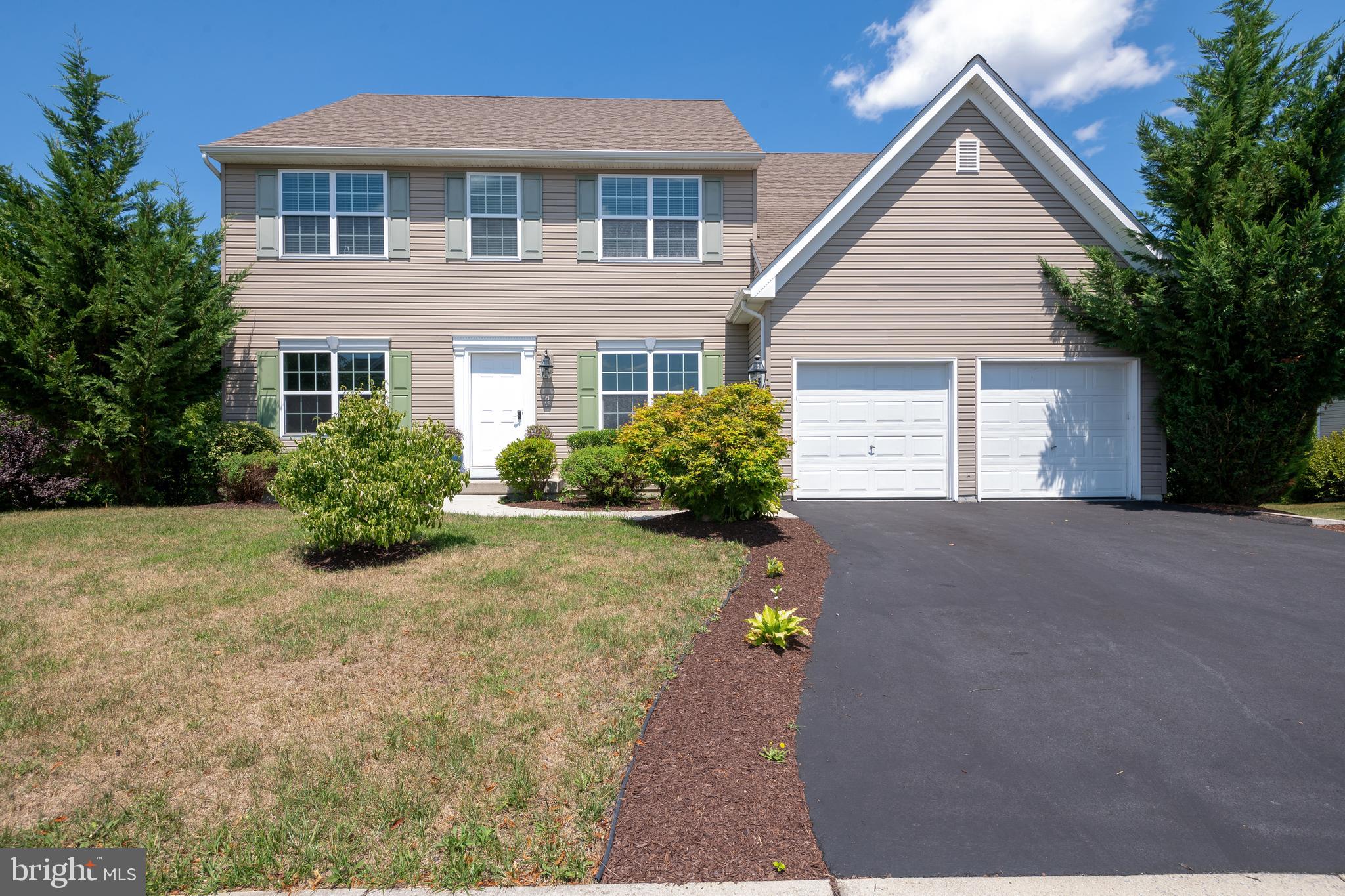 a view of a house with a yard and plants