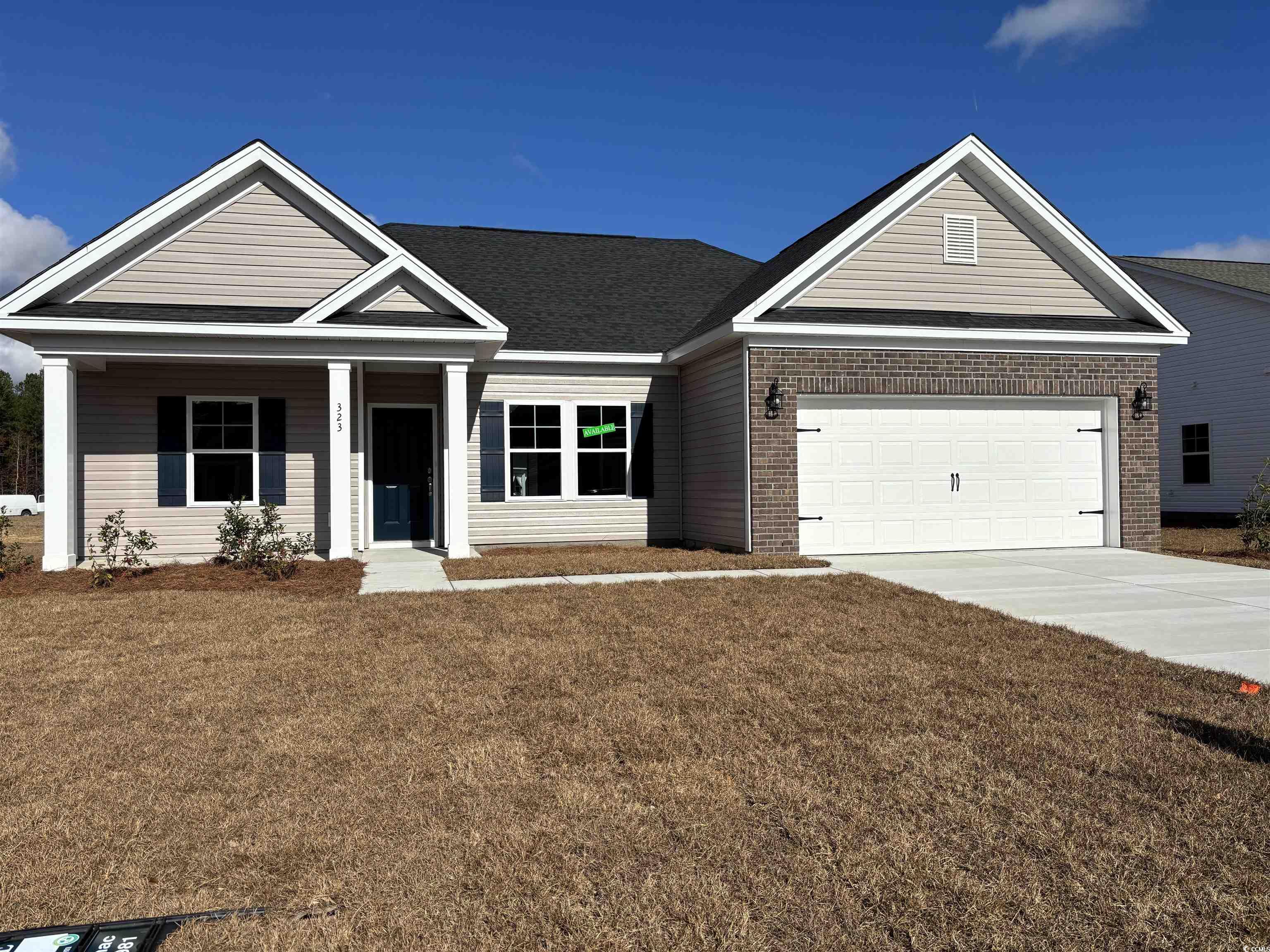 View of front of home with a garage and a front la